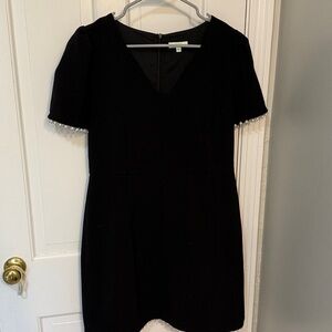 Black V-neck dress with pearl accents on sleeves